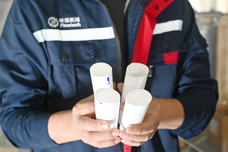 A technician is displaying a hose sample.