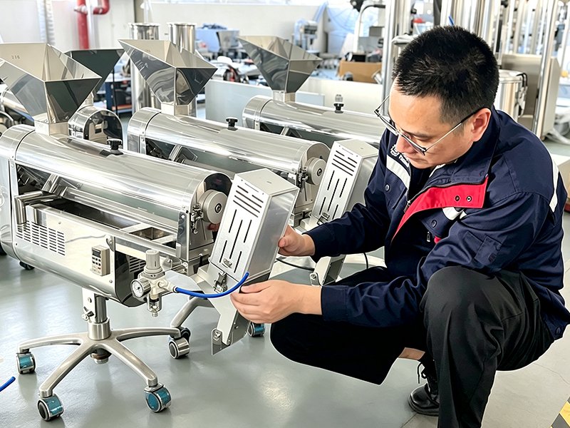 The technician was adjusting the capsule polishing machine