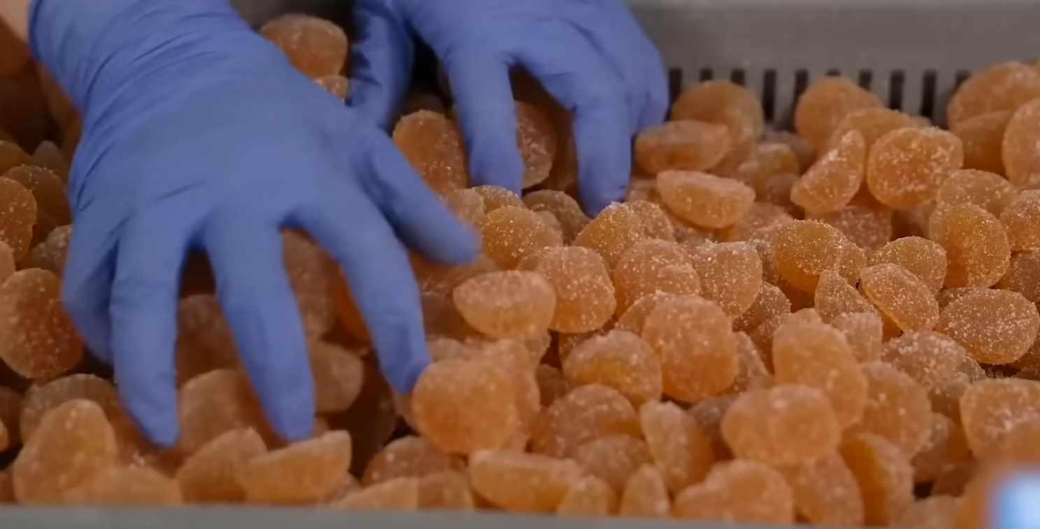 Manually inspect the gummies for defects in shape