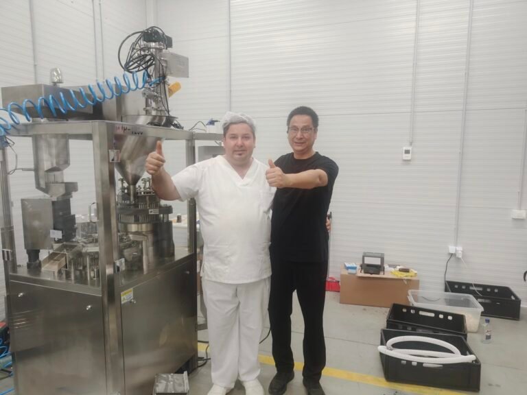 Blog 11 Finetech Technical Director & Romanian Client Posing Beside NJP-1200 Capsule Filling Machine