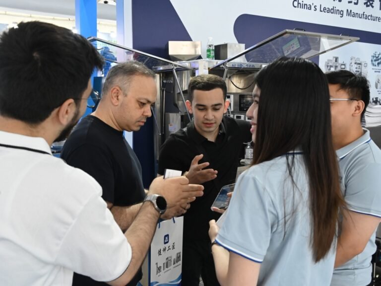 The Azerbaijan‑based client takes a group photo with Finetech sales representative Bella